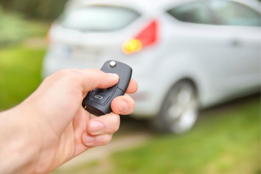 Man checking car security systems